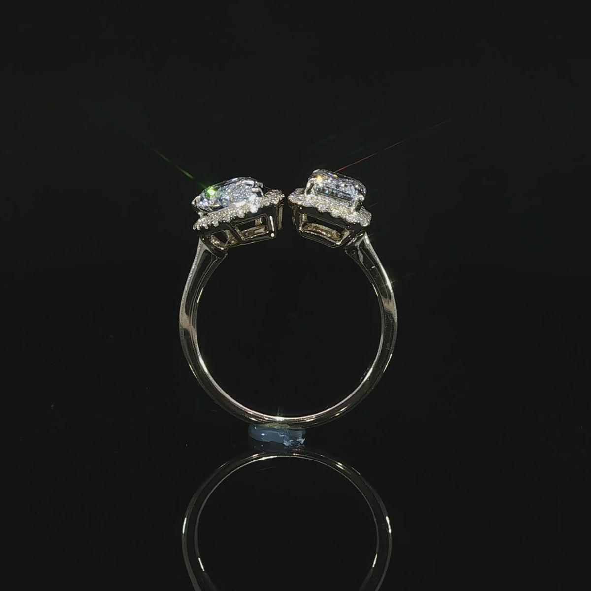 Modern 3.30 CTW Toi et Moi engagement ring with emerald and pear shaped lab grown diamonds and halo accents.