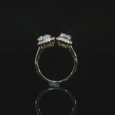 Modern 3.30 CTW Toi et Moi engagement ring with emerald and pear shaped lab grown diamonds and halo accents.
