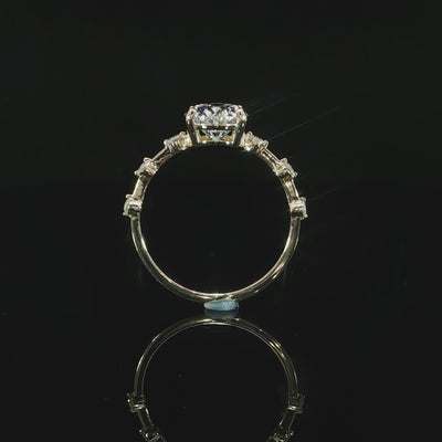Video of 2 carat oval diamond ring with station-set accent diamonds in 14K yellow gold.
