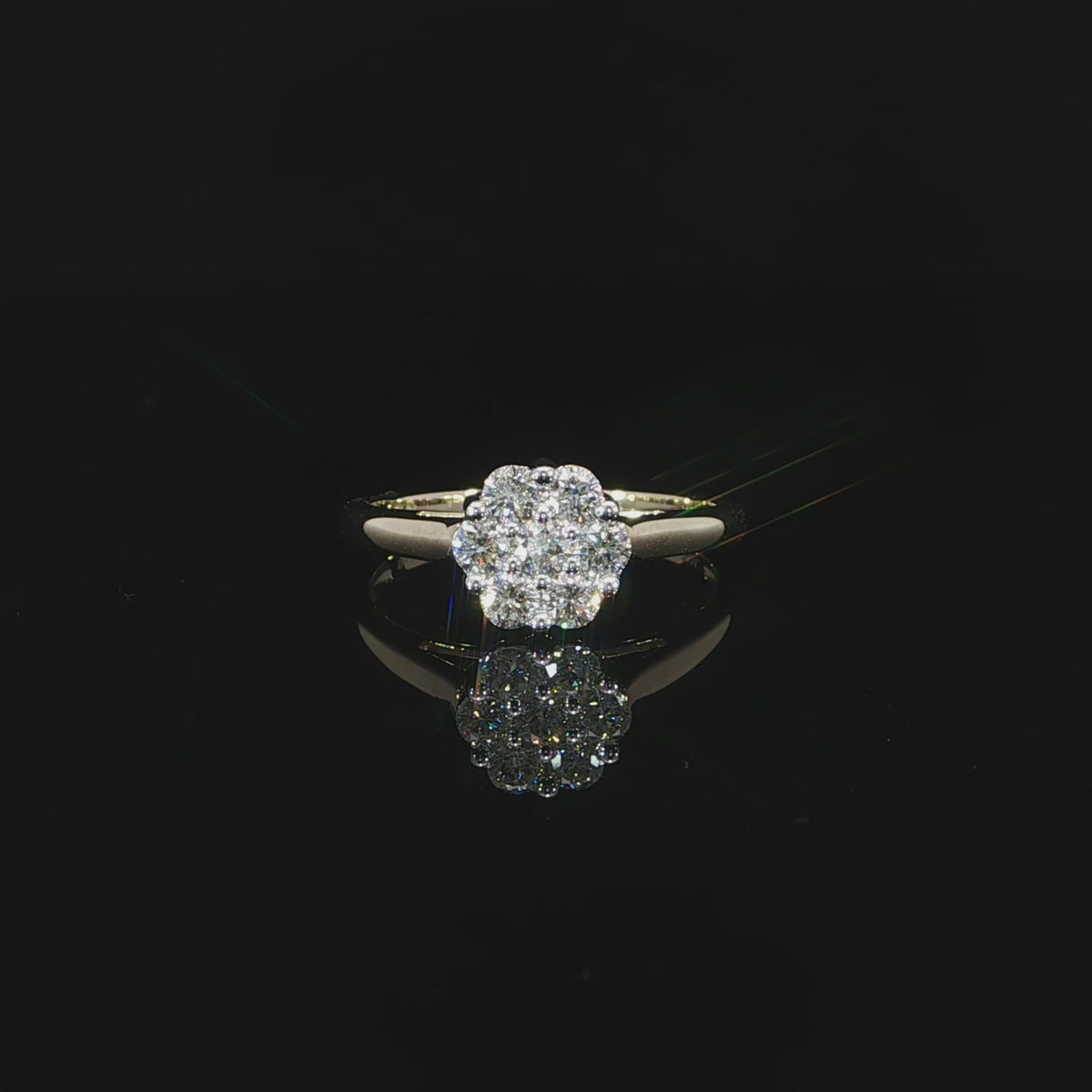 Video of a 10K yellow gold 0.50 CTW round cluster ring with one diamond surrounded by seven diamonds.