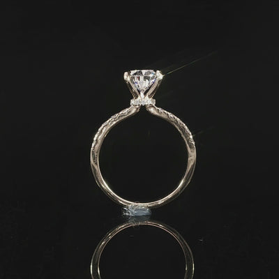 Modern pear-shaped diamond engagement ring with a sparkling diamond band in 14K yellow gold.