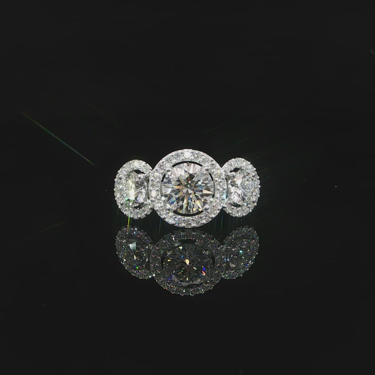 Video of a round three-stone diamond ring with individual halos in 14K white gold