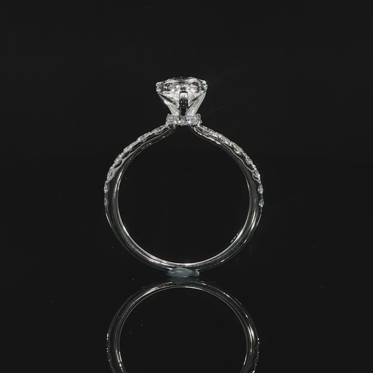 Video of the sides 2CT pear diamond ring showing the raised setting, hidden halo, and pavé diamond band.