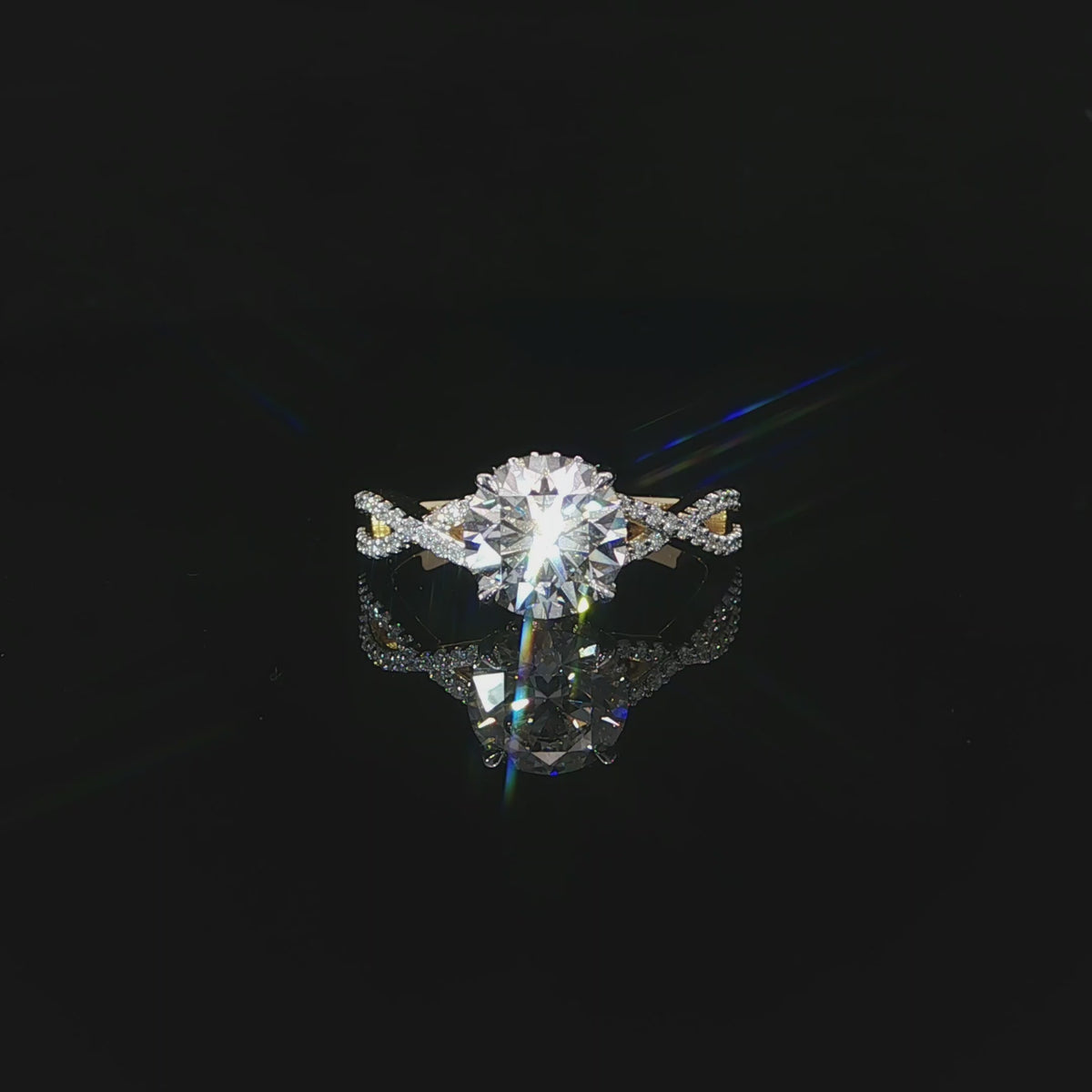Modern round diamond engagement ring with a hidden halo and flowing yellow gold twist band.