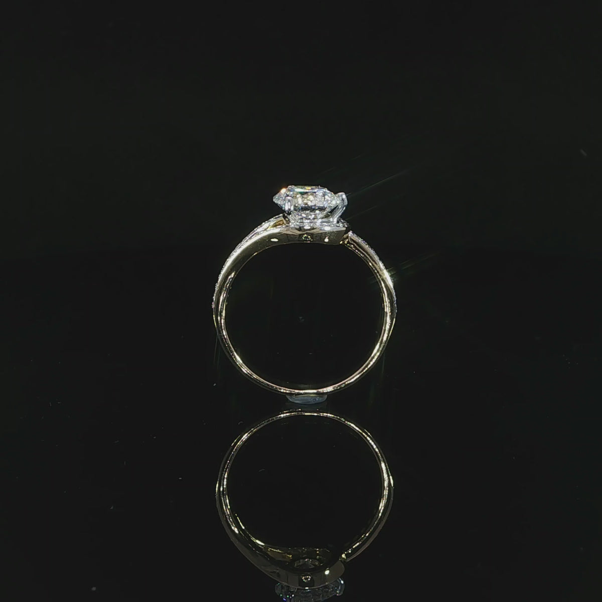 Video of a round brilliant diamond engagement ring with pavé-set bypass shoulders and a raised center setting.