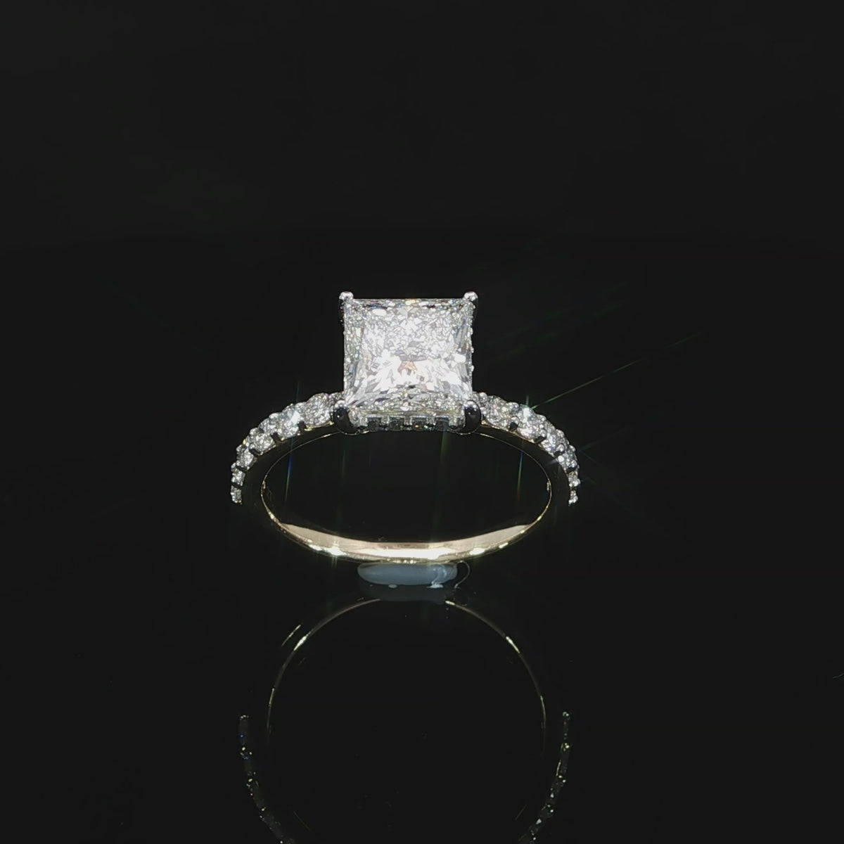 Video of a princess cut diamond ring showing the elevated setting and pavé diamond shoulders