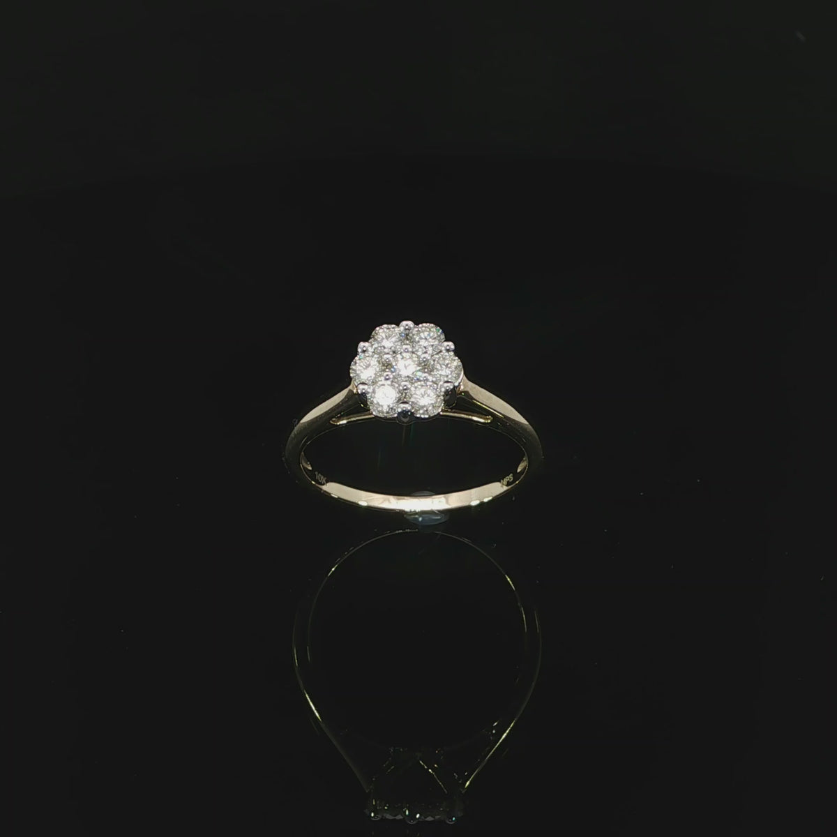 Angled video 10K yellow gold 0.50 CTW ring with seven round natural diamonds arranged in a flower-like cluster.