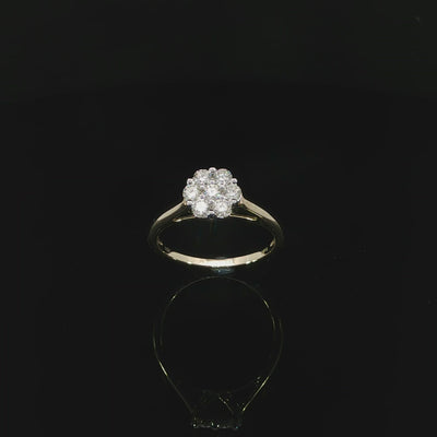 Angled video 10K yellow gold 0.50 CTW ring with seven round natural diamonds arranged in a flower-like cluster.