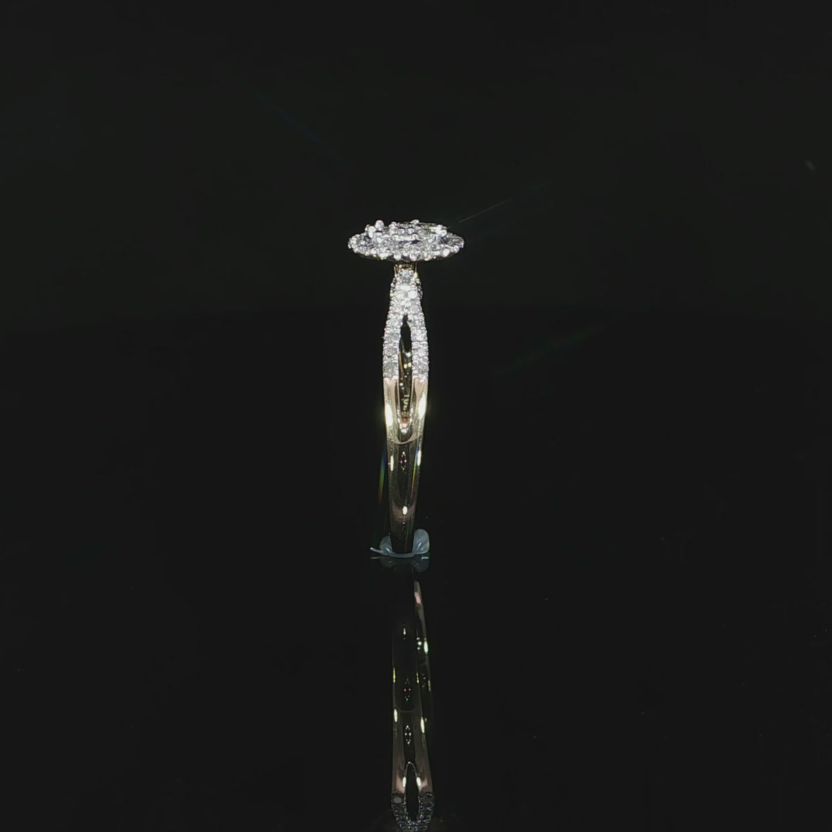 Upright profile of a 10K yellow gold 0.40 CTW diamond halo ring showing its open gallery.