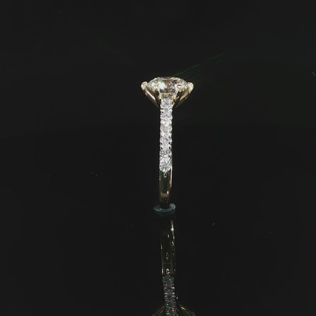 Detailed video of a round diamond engagement ring with a secure six-prong setting in yellow gold