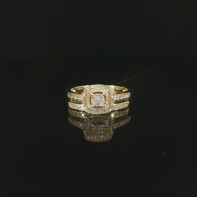 Video of a 10K yellow gold double-halo bridal set resting on a glossy black surface, with both diamond bands reflected below.