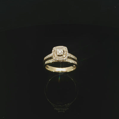 Angled video of a 10K yellow gold double-halo ring alongside its matching diamond wedding band.