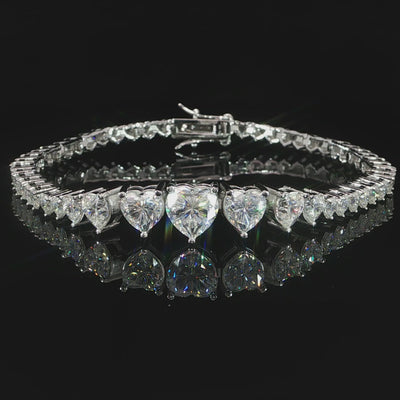 Video of sterling silver graduated heart moissanite bracelet displayed on a reflective surface