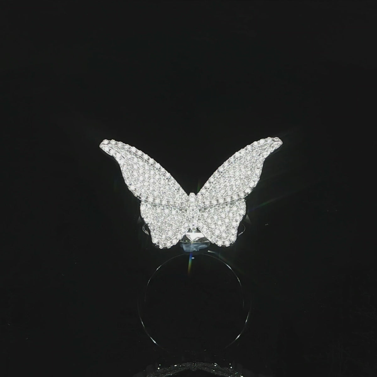 Statement butterfly cocktail ring measuring 18 by 30 millimeters with sparkling moissanite stones.
