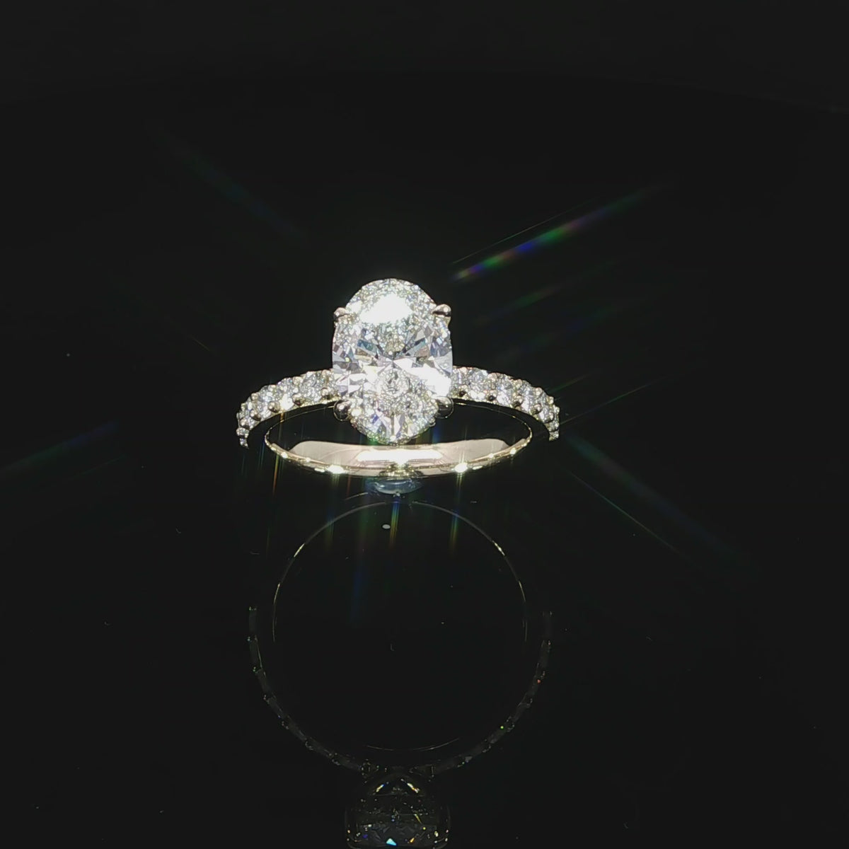 Angled video of yellow gold engagement ring featuring an E color, VS1 clarity oval lab-grown center diamond.