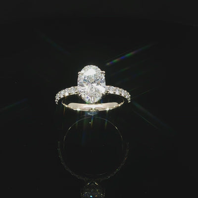 Angled video of yellow gold engagement ring featuring an E color, VS1 clarity oval lab-grown center diamond.