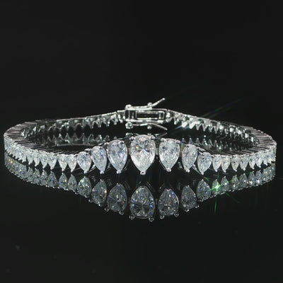 Close-up video of brilliant VVS moissanite pear stones in sterling silver prong settings.