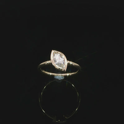 14K yellow gold engagement ring with an F-G color VS marquise lab grown diamond.