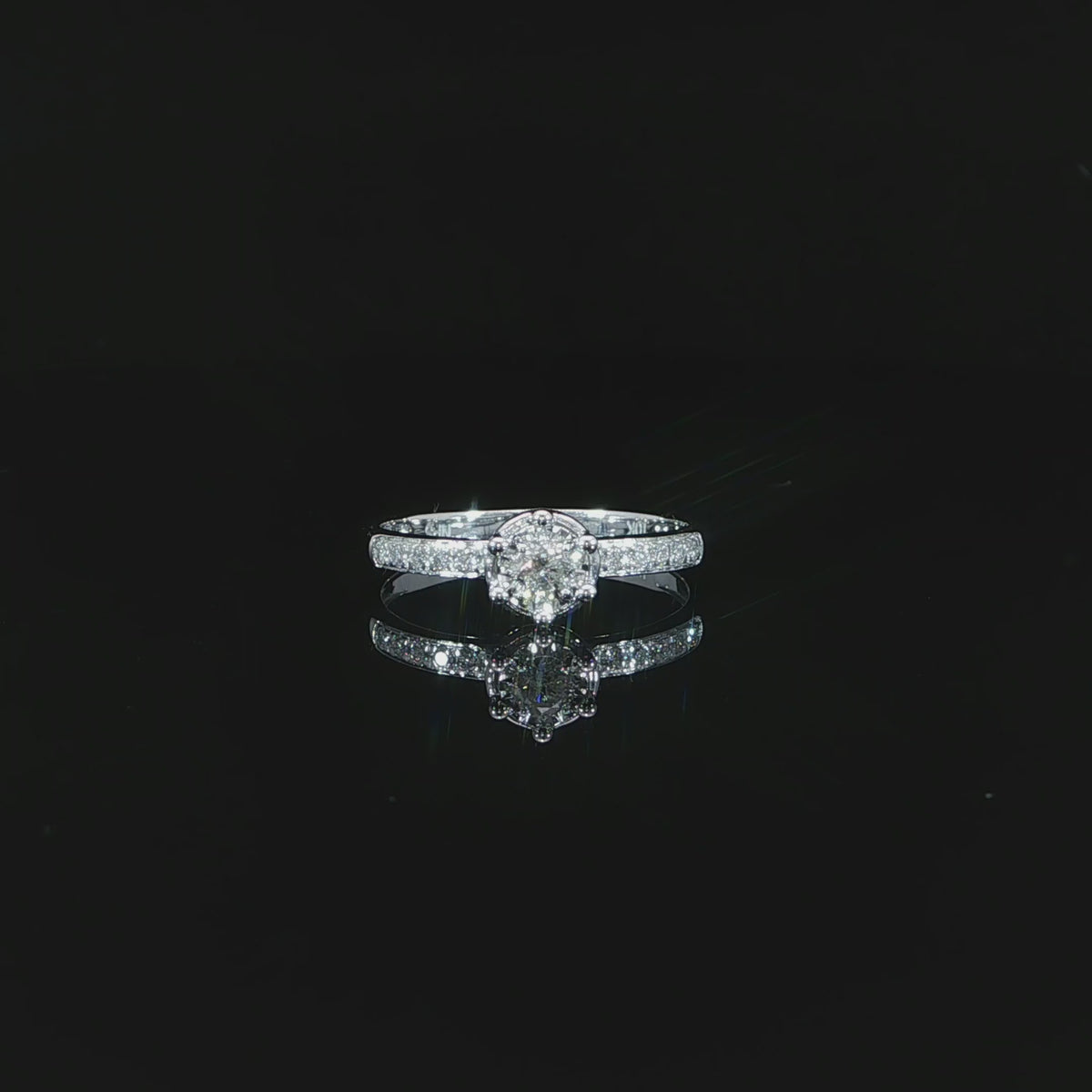 A 10K white gold 0.22 CTW diamond ring resting flat video showing its round illusion setting and diamond band.