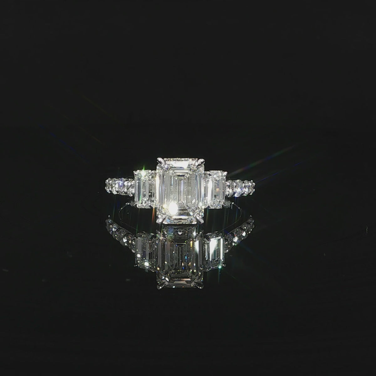 Elegant 3-stone emerald cut engagement ring with pave diamonds