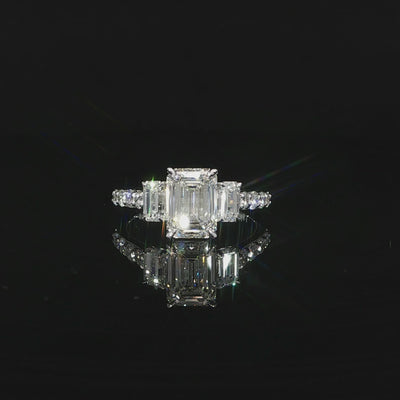 Elegant 3-stone emerald cut engagement ring with pave diamonds