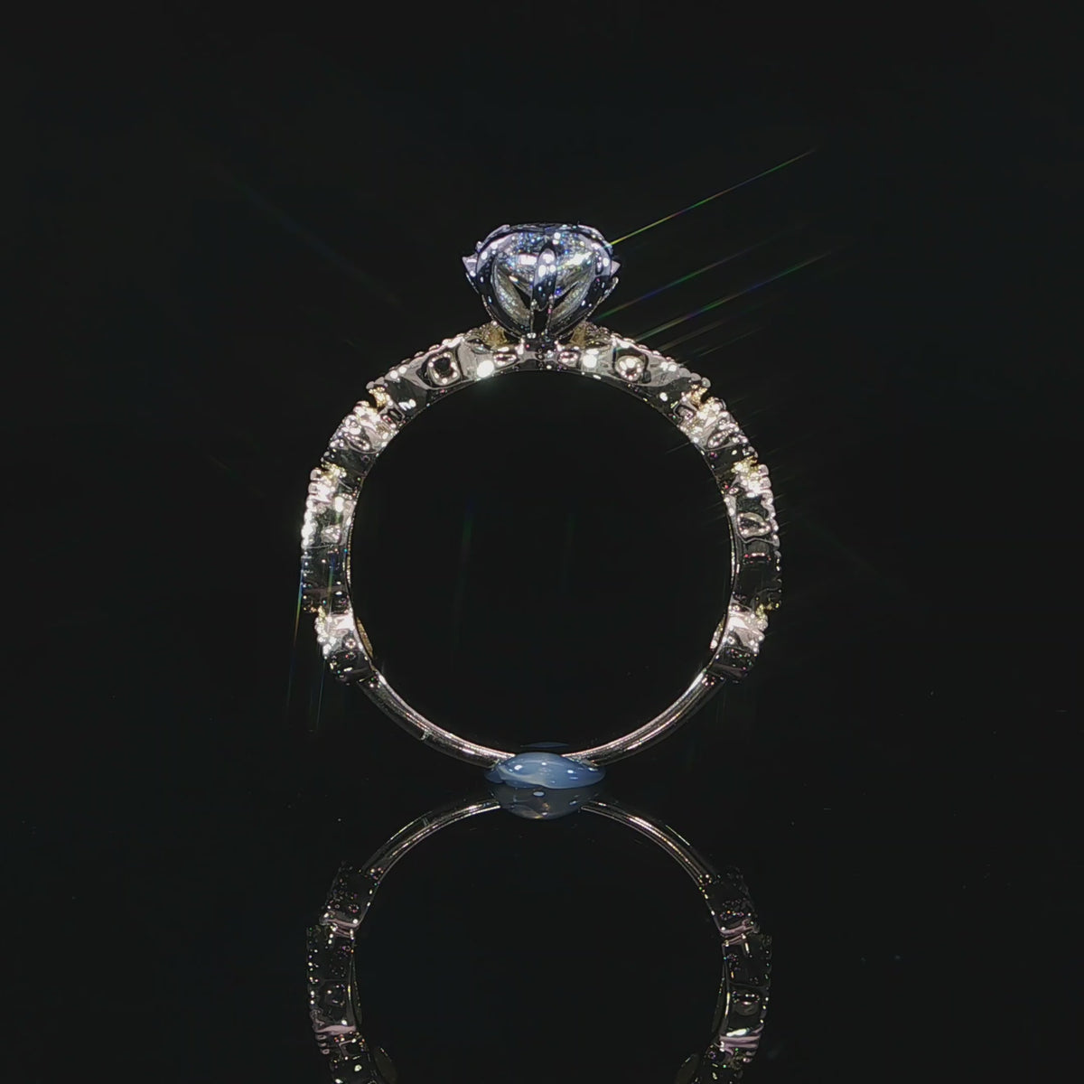 Detailed video of lab grown diamond engagement ring with bezel-set accent diamonds along the milgrain borders