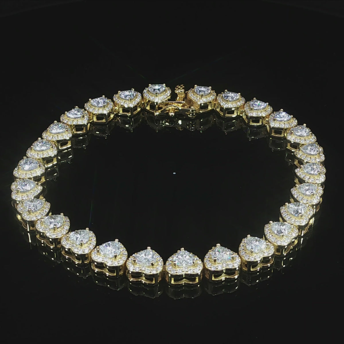 Continuous row of heart-cut moissanite with sparkling halo settings