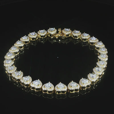 Continuous row of heart-cut moissanite with sparkling halo settings