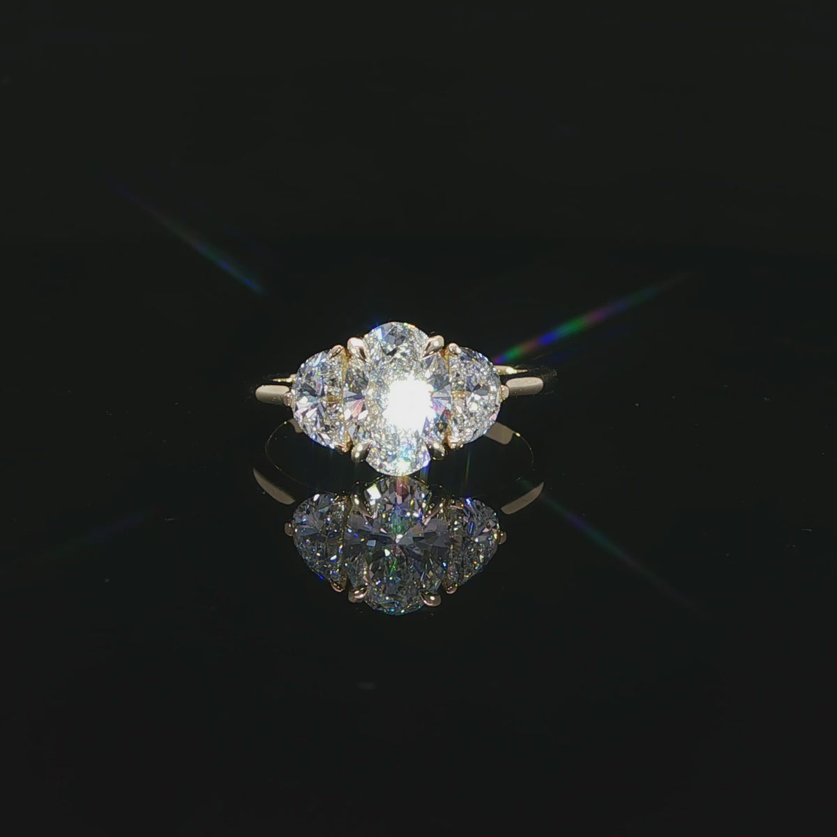 Detailed video of the 1.52-carat oval center diamond between two half-moon side stones.