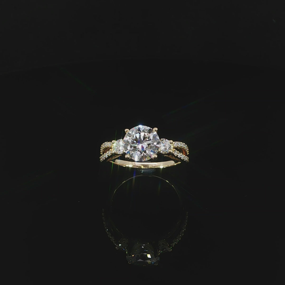 14K Gold round diamond ring with a split shank on a reflective black background