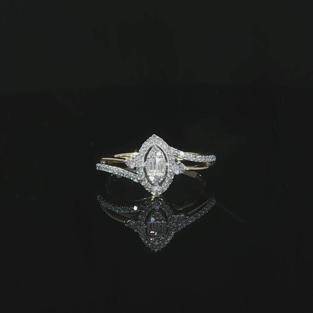 A 10K yellow gold 0.29 CTW split-shank diamond halo ring resting above its reflection on a black surface.