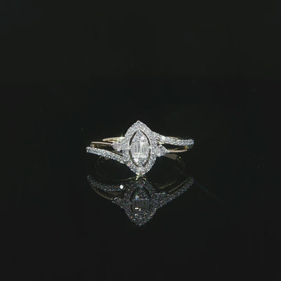 A 10K yellow gold 0.29 CTW split-shank diamond halo ring resting above its reflection on a black surface.