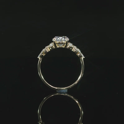 14K yellow gold engagement ring with a 2 carat E color VS1 oval lab grown center diamond and side accents.