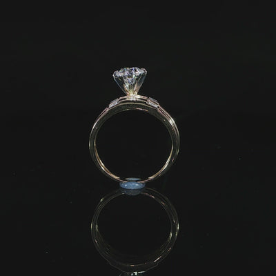 Profile of a 1.00 ct round lab-grown diamond in a raised prong setting with a matching yellow gold band.