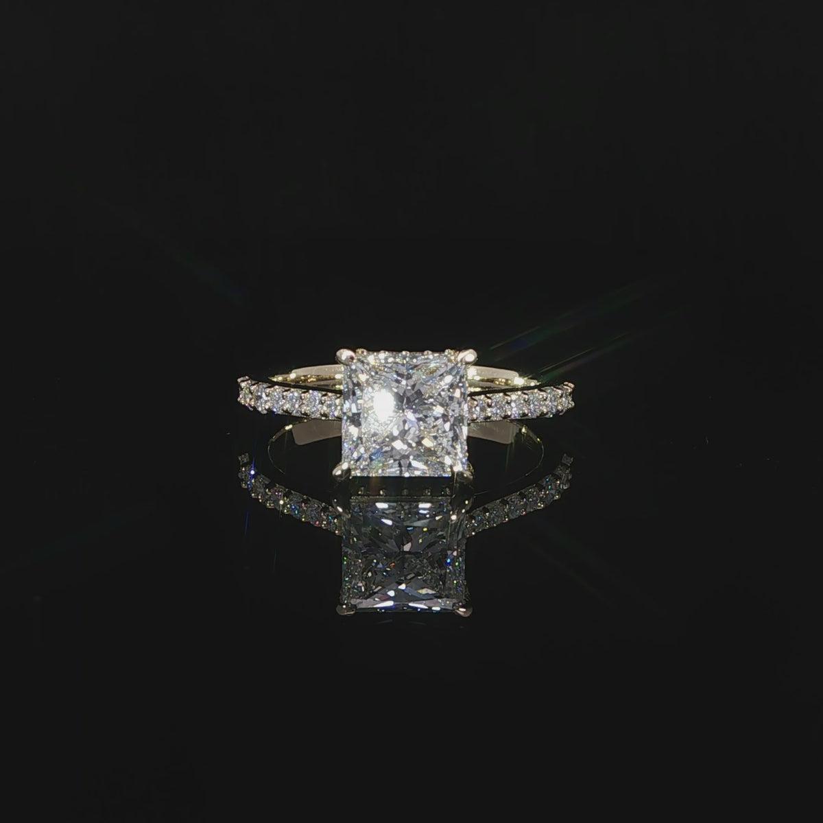 Princess cut lab grown diamond engagement ring featuring a hidden halo beneath the center stone in 14K yellow gold.