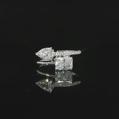 Asymmetrical Toi et Moi ring with radiant and pear shaped lab grown diamonds in a modern two-stone setting.