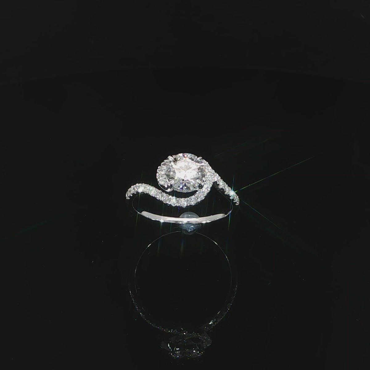 Angled video showing the transition from diamond-set shoulders to the polished white gold band.