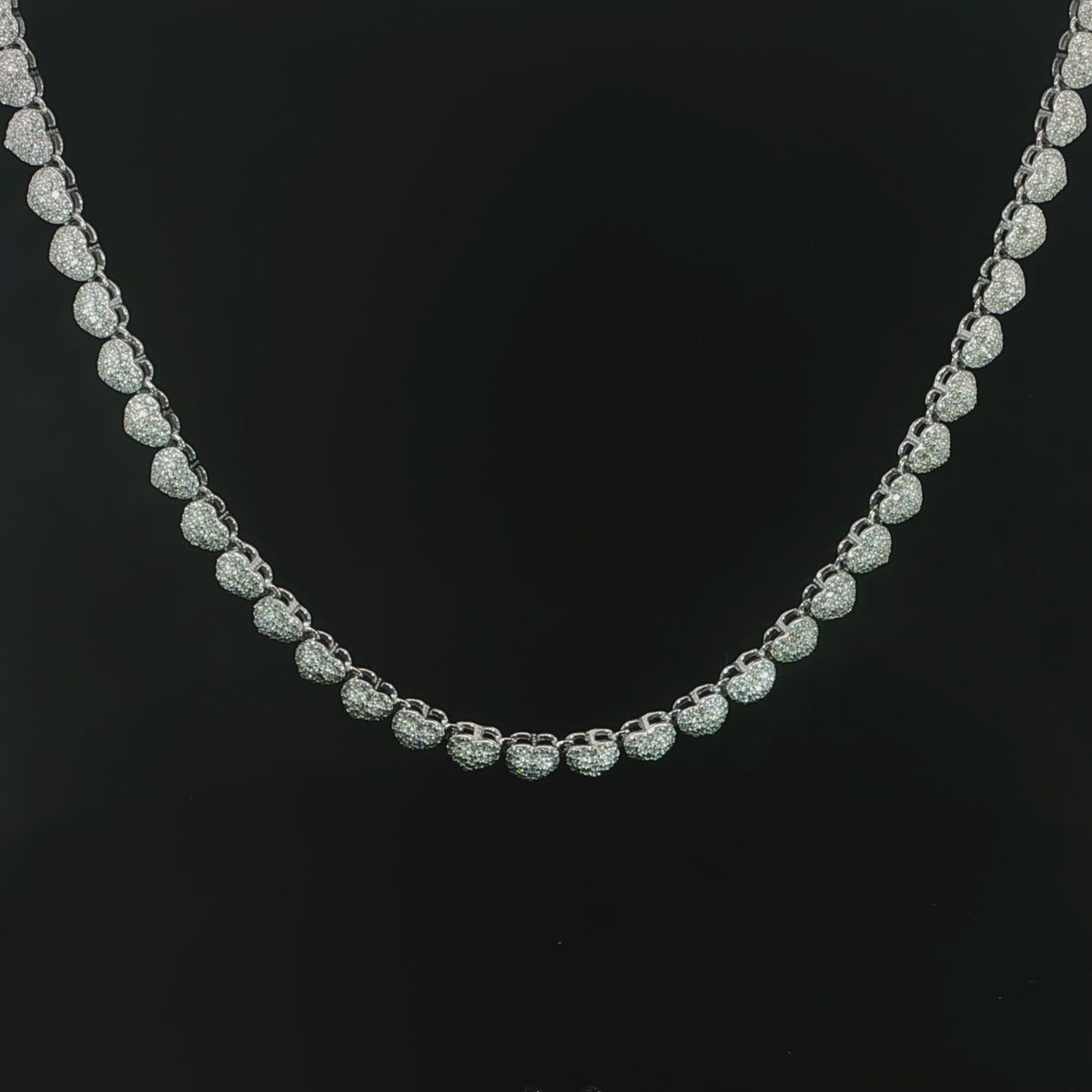 Petite heart halo tennis necklace featuring 10.20 CTW of VVS moissanite