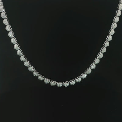 Petite heart halo tennis necklace featuring 10.20 CTW of VVS moissanite