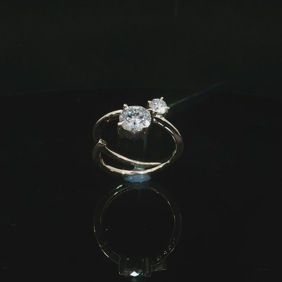 Angled video of two-stone diamond ring with 14k yellow gold band wrapping around