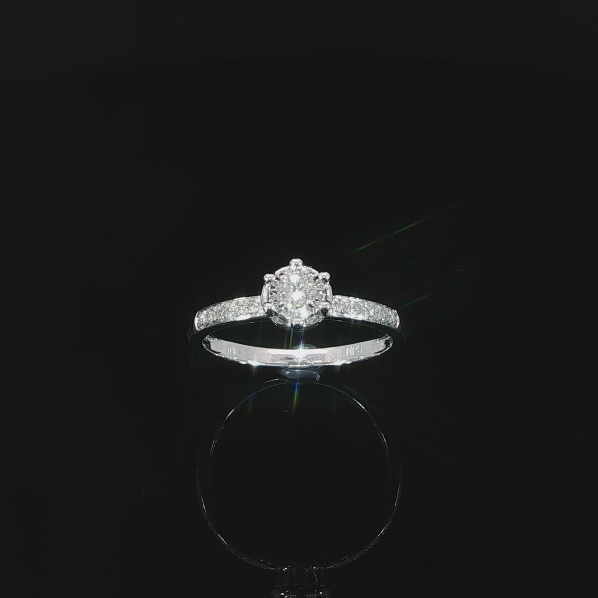 Angled video of a 10K white gold 0.22 CTW natural diamond ring with a round illusion setting and diamond band