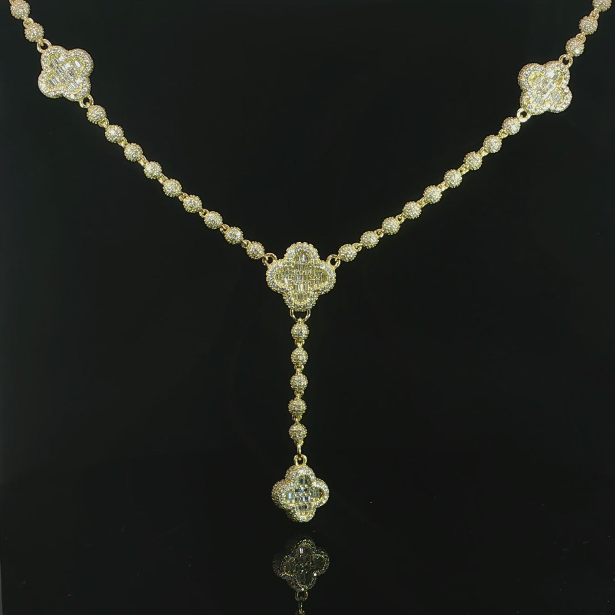 Clover necklace featuring baguette-cut and round VVS moissanite