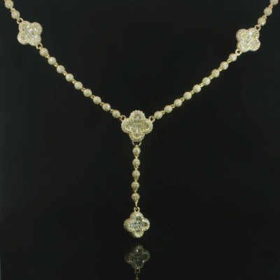 Clover necklace featuring baguette-cut and round VVS moissanite