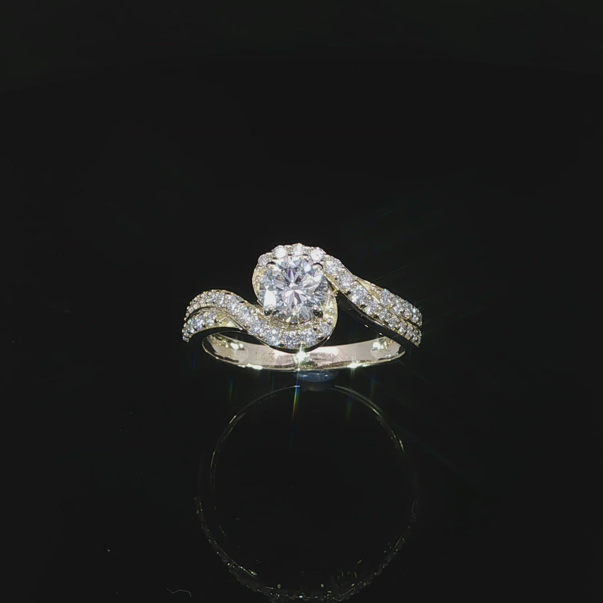 Round diamond engagement ring with a swirling pavé-set band in polished 14K yellow gold.