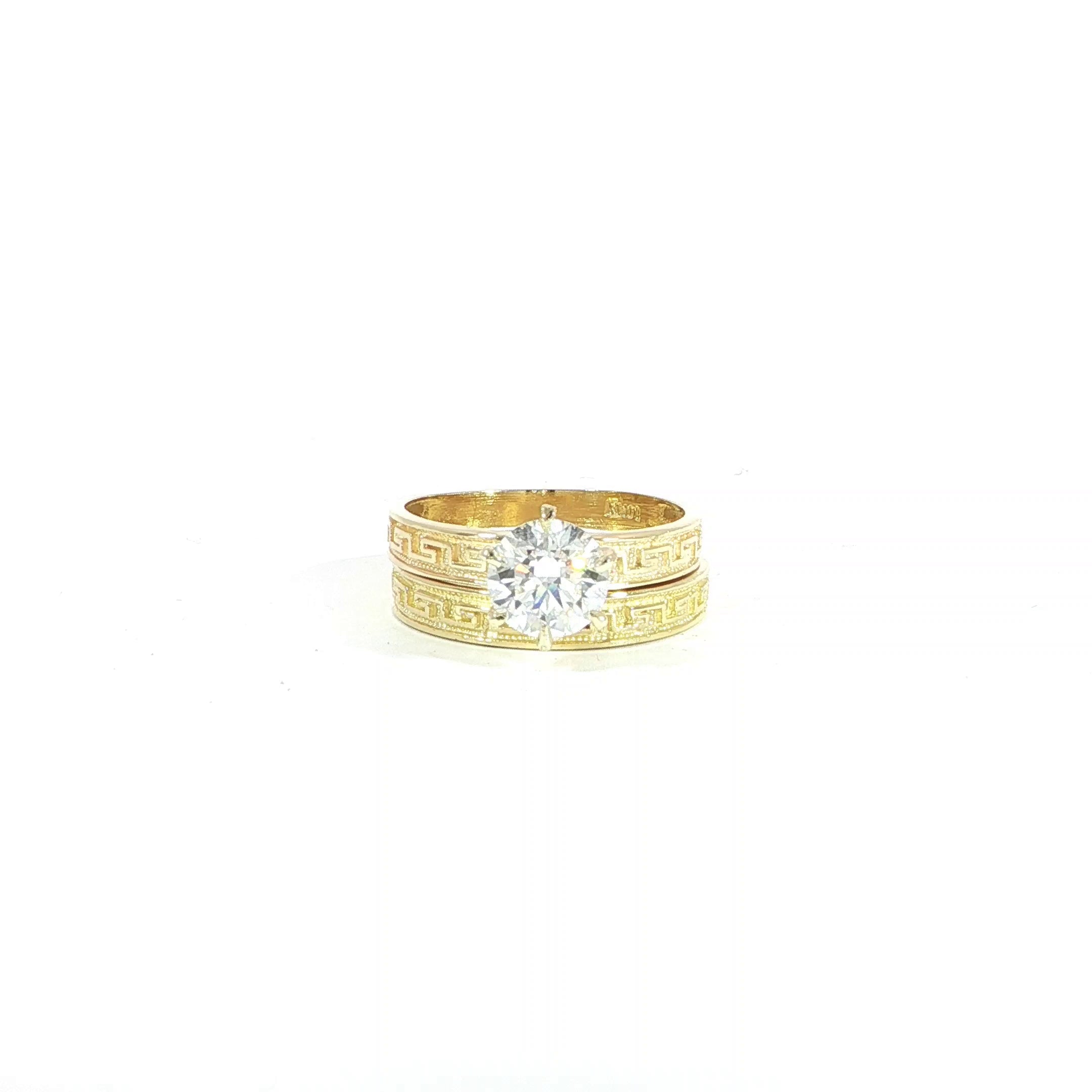 Video of closeup greek key engraved wedding set