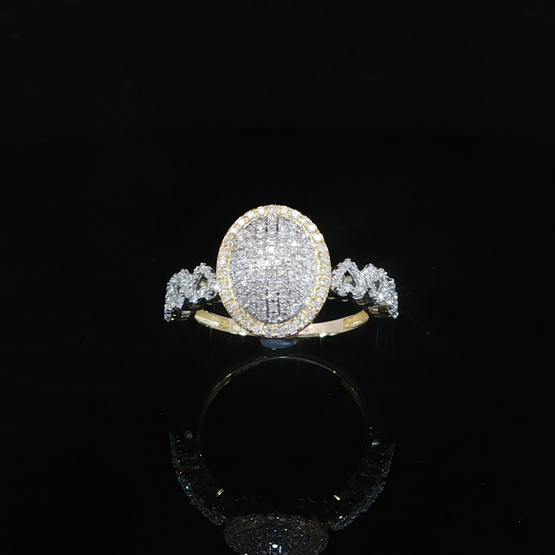 Luxury oval diamond cluster ring with yellow gold and heart link detailing