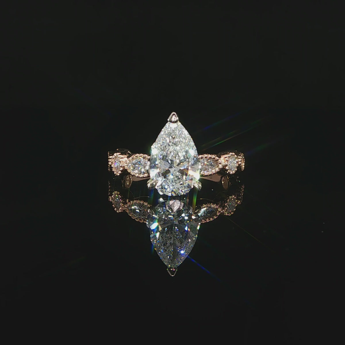 2.71 CTW lab grown diamond engagement ring with a 2 carat pear center stone in 14K rose gold.