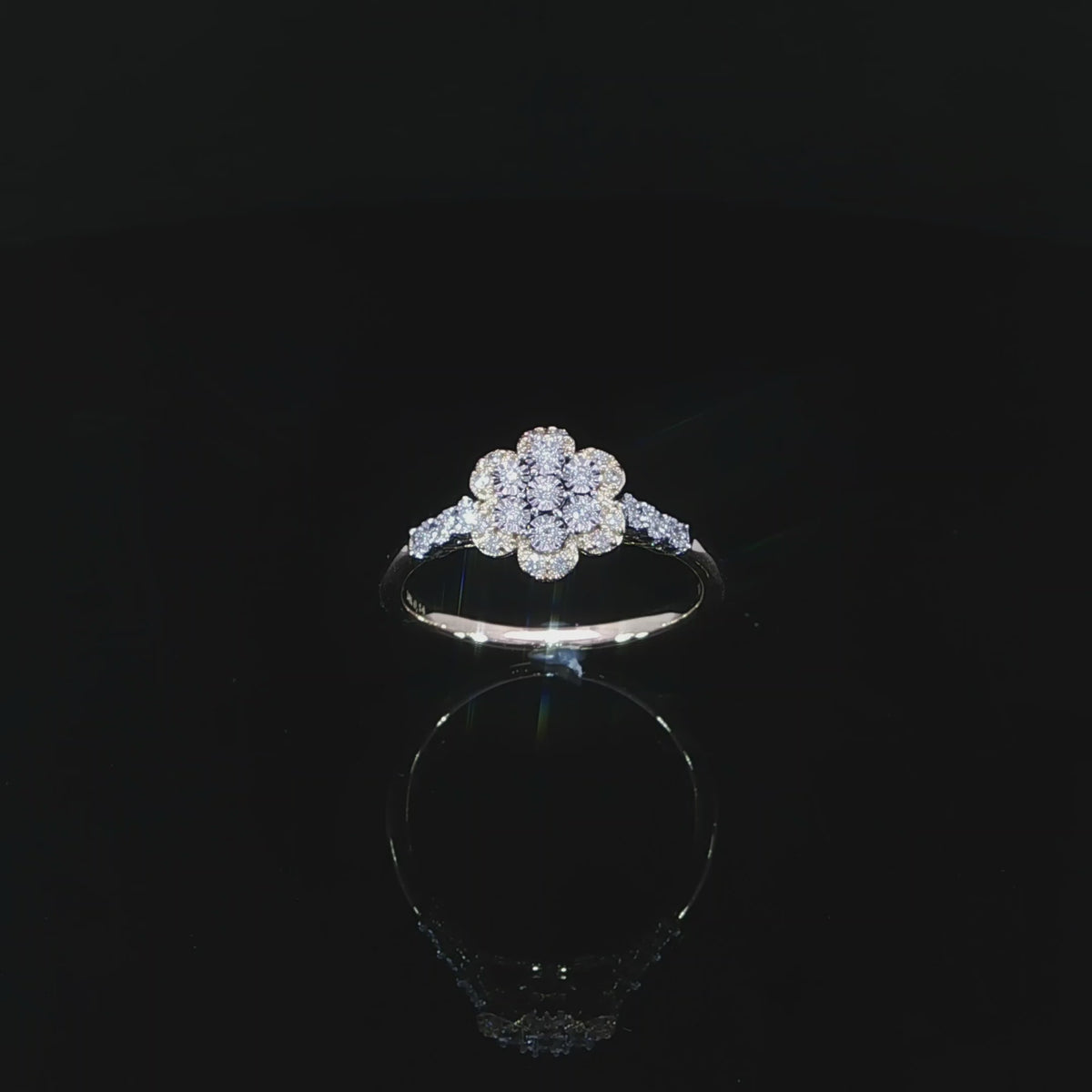 Angled video of 10K yellow gold 0.14 CTW diamond promise ring showing its flower design and shoulder accents.