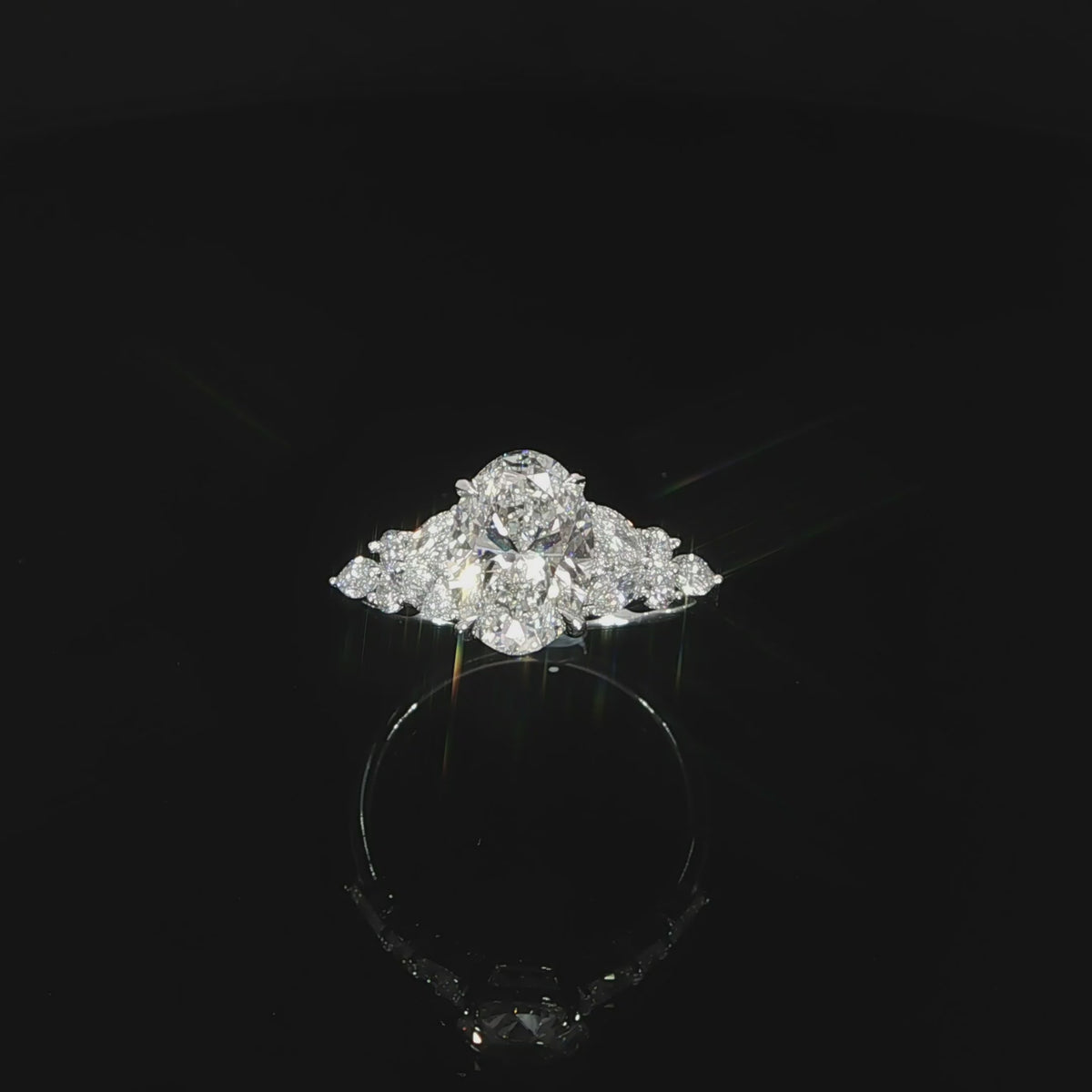 2.52 CTW lab grown diamond engagement ring featuring a 2 carat oval center with round and marquise accent diamonds.
