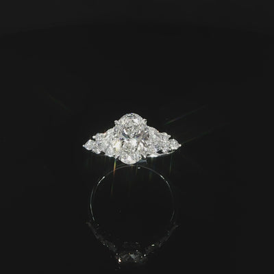 2.52 CTW lab grown diamond engagement ring featuring a 2 carat oval center with round and marquise accent diamonds.